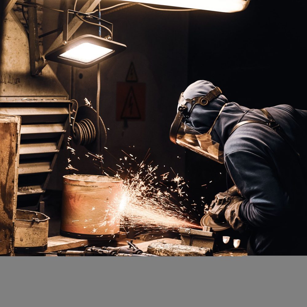 man-protective-mask-is-cutting-metal-sparks-are-flying-away